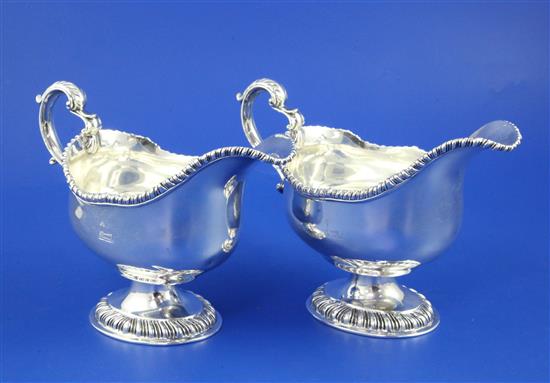 A pair of George V silver pedestal sauceboats by Carrington & Co, 28.5 oz.